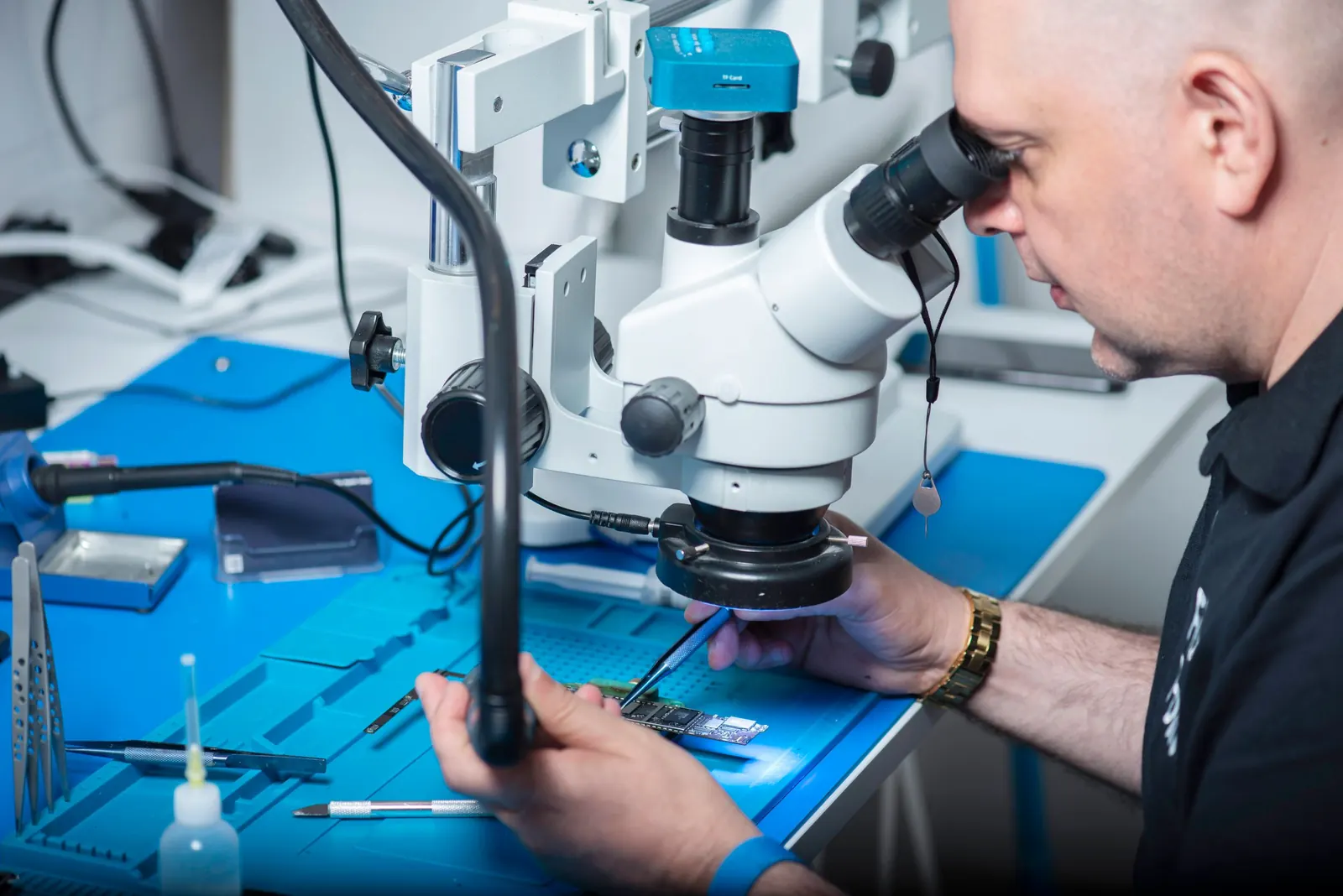 Illustration of an AxiTech biomedical technician servicing a medical device
